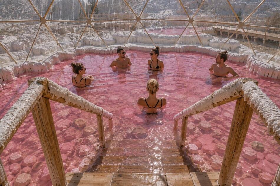 Rendering of bathers relaxing in the pink soaking pool