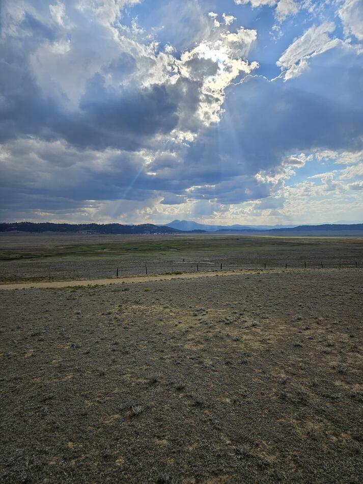 Sunbeams breaking through storm clouds over the prairie