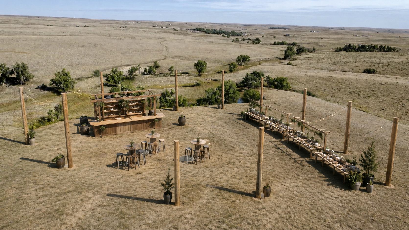 Aerial view of the outdoor bar and long feast tables on the open prairie