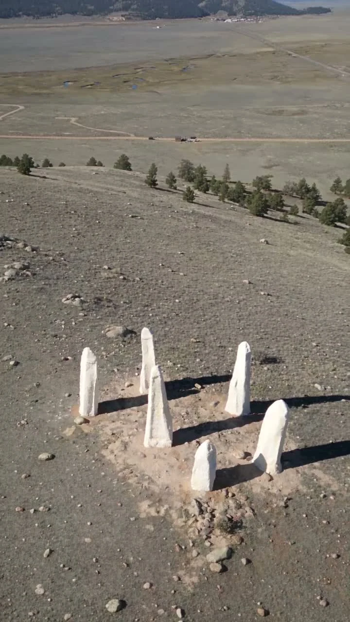 Aerial view of the six white standing stones and surrounding landscape